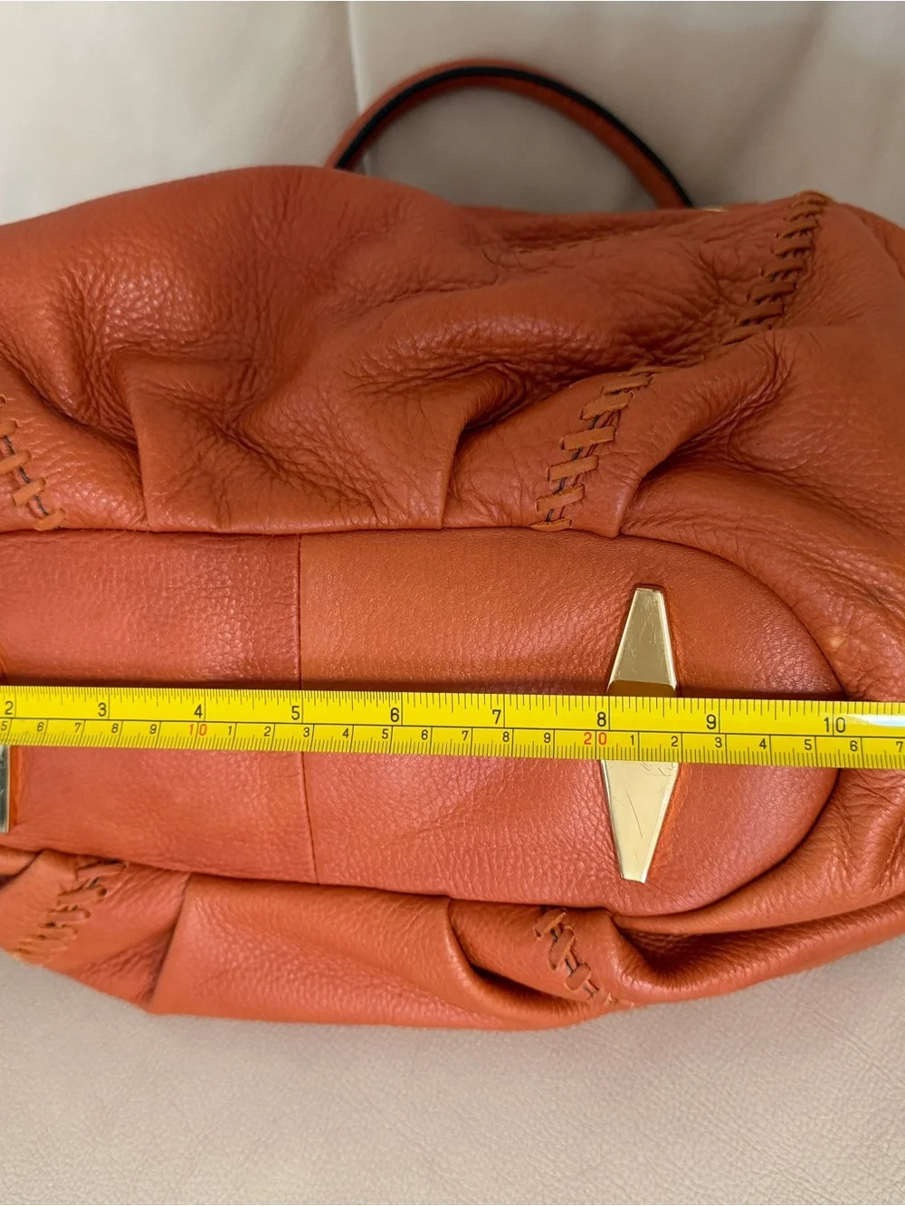 Orange leather handbag appears to be a slouchy style by orYany